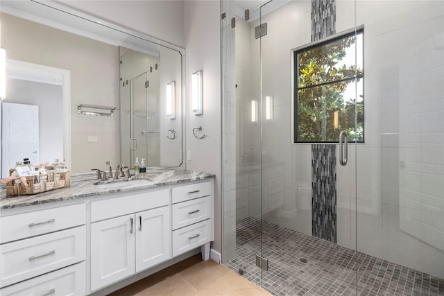 bathroom featuring walk in shower, tile patterned flooring, and vanity