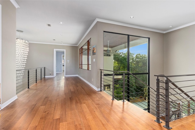 hallway with hardwood / wood-style floors and crown molding