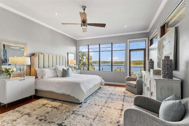 bedroom with ceiling fan, multiple windows, a water view, and crown molding