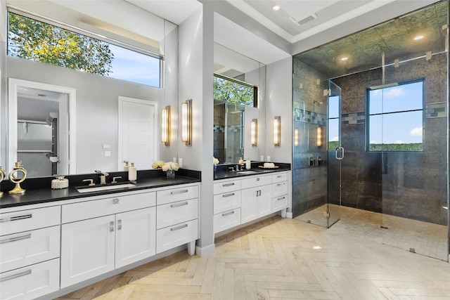 bathroom featuring a shower with door, vanity, a high ceiling, and parquet floors