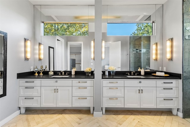 bathroom featuring a shower with door, parquet flooring, a wealth of natural light, and vanity