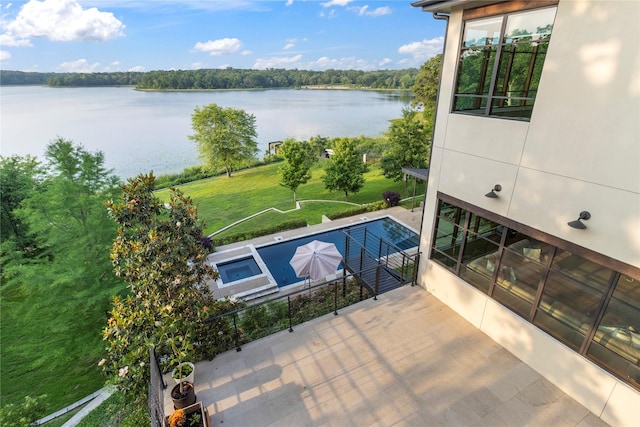 view of swimming pool featuring a water view