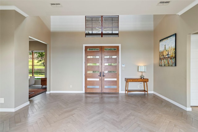 foyer entrance featuring french doors and parquet flooring