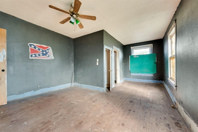 empty room featuring wood-type flooring and ceiling fan