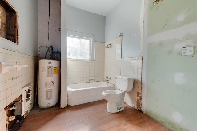 bathroom featuring wood-type flooring, electric water heater, tiled shower / bath combo, and toilet