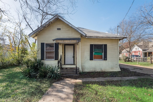 bungalow-style home featuring a front yard