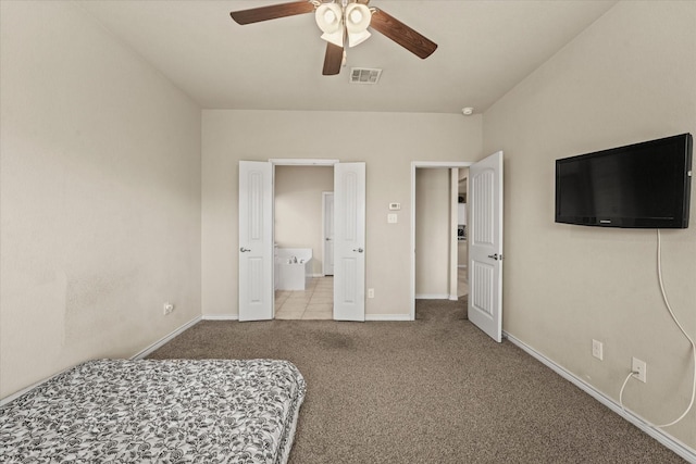 bedroom featuring ensuite bathroom, ceiling fan, and light carpet