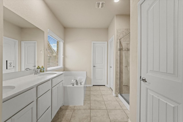 bathroom featuring vanity, tile patterned floors, and separate shower and tub