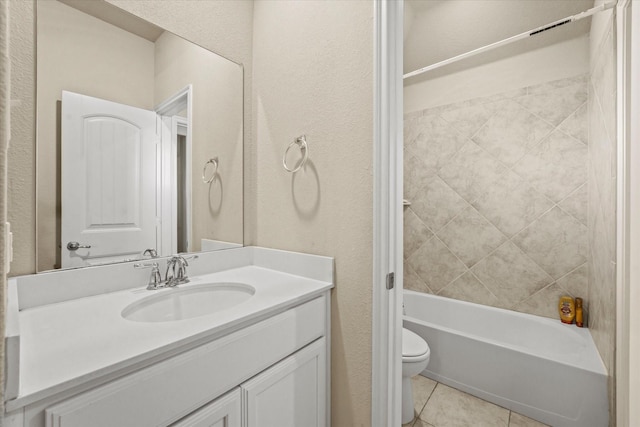 full bathroom with toilet, tiled shower / bath, tile patterned floors, and vanity