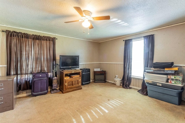 interior space with ornamental molding, a textured ceiling, and ceiling fan