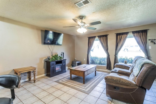 tiled living room featuring a textured ceiling and ceiling fan