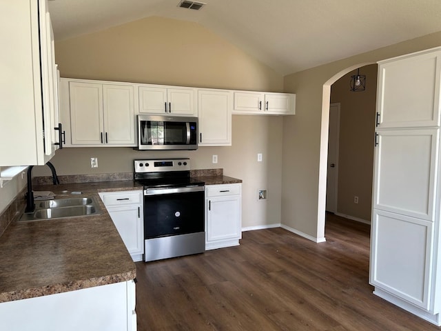 kitchen featuring dark hardwood / wood-style floors, stainless steel appliances, lofted ceiling, white cabinetry, and sink