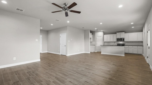 unfurnished living room featuring ceiling fan and light hardwood / wood-style flooring