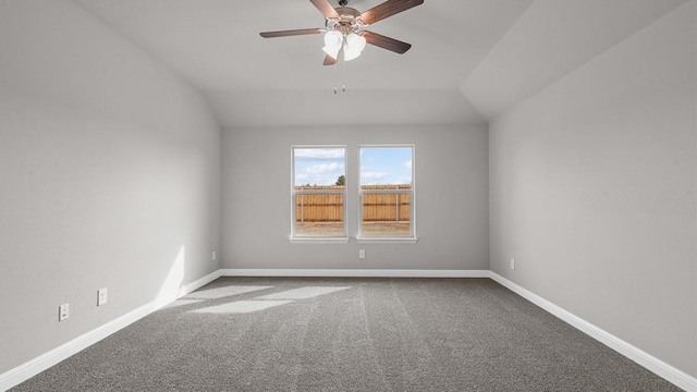 unfurnished room featuring lofted ceiling, ceiling fan, and carpet flooring