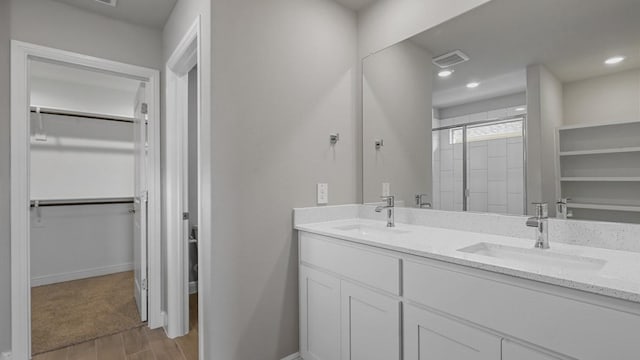 bathroom with walk in shower and vanity