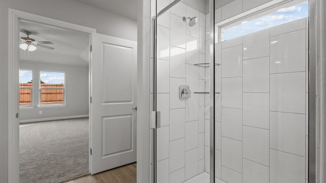 bathroom with walk in shower and ceiling fan