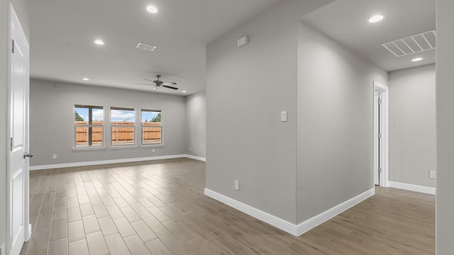 spare room featuring hardwood / wood-style flooring and ceiling fan