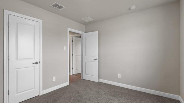 unfurnished bedroom featuring dark colored carpet