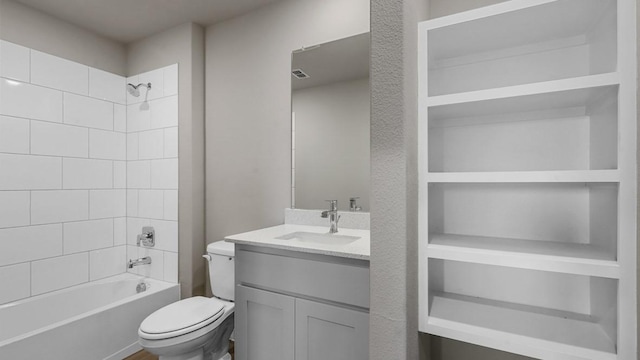 full bathroom with tiled shower / bath combo, vanity, and toilet