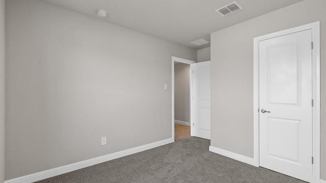 unfurnished bedroom featuring dark carpet