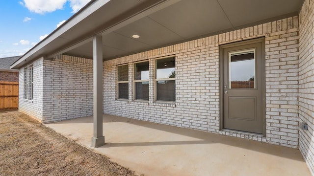 entrance to property featuring a patio