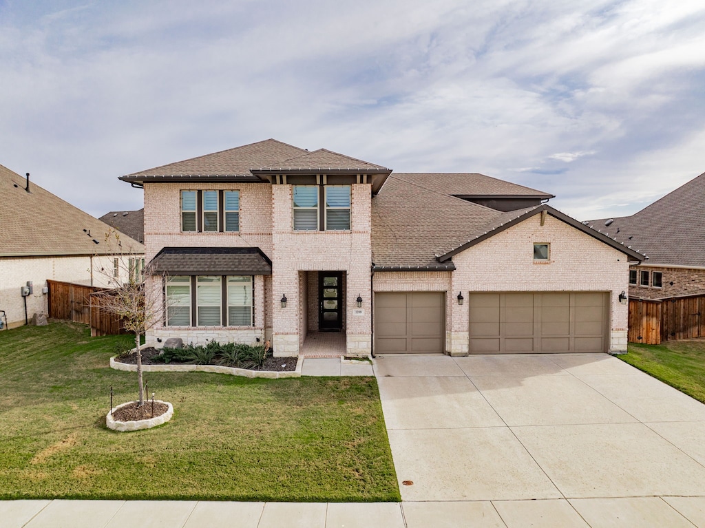 front facade featuring a front lawn and a garage