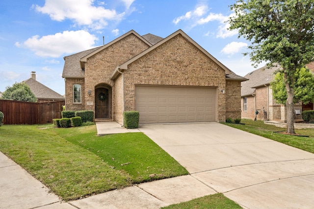 view of front of property with a garage and a front lawn