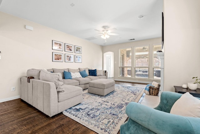 living room with ceiling fan and dark hardwood / wood-style flooring