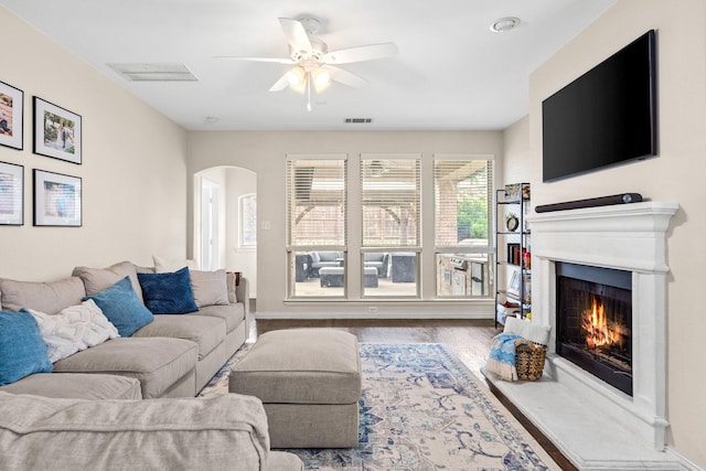 living room featuring ceiling fan and wood-type flooring