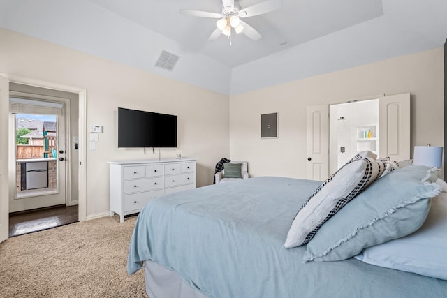 bedroom featuring vaulted ceiling, electric panel, ceiling fan, a tray ceiling, and light colored carpet