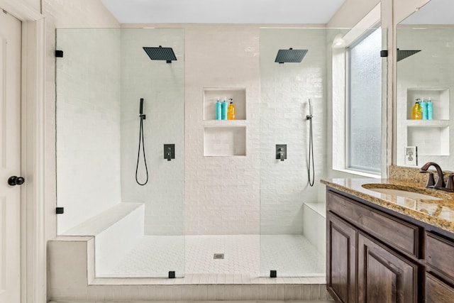 bathroom with an enclosed shower and vanity