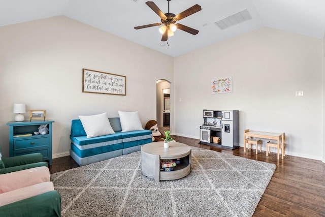 living room featuring ceiling fan, lofted ceiling, and dark hardwood / wood-style floors