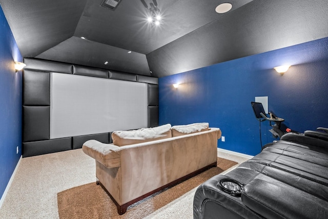 carpeted cinema featuring vaulted ceiling