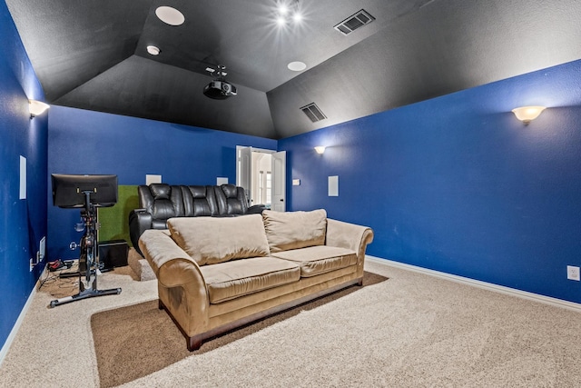 carpeted cinema room featuring lofted ceiling