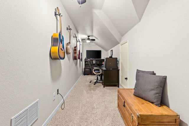 carpeted office space featuring lofted ceiling and ceiling fan