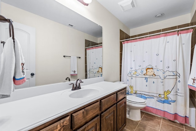 bathroom with toilet, vanity, tile patterned flooring, and a shower with curtain