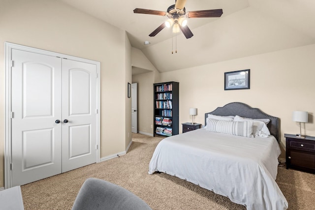 carpeted bedroom featuring vaulted ceiling, ceiling fan, and a closet