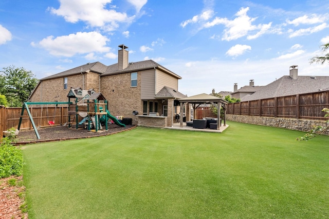 rear view of house with a lawn, a gazebo, a playground, and an outdoor living space