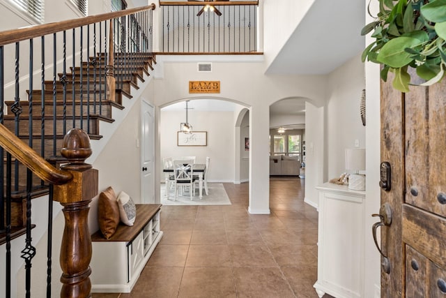 entryway featuring a high ceiling and tile patterned floors