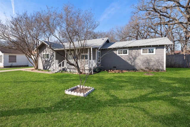 back of house featuring covered porch and a yard