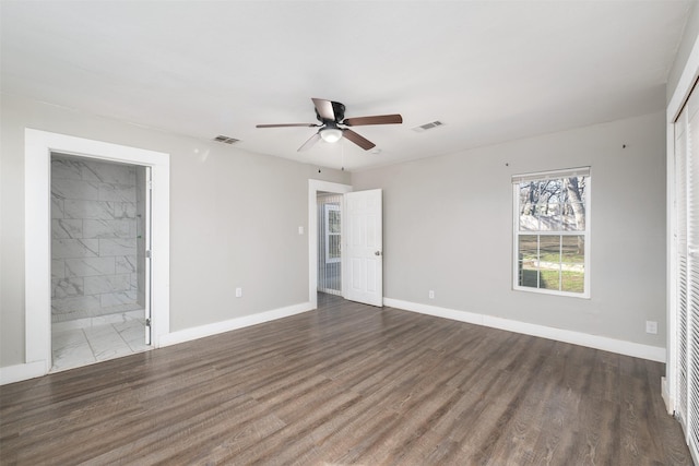 spare room featuring ceiling fan and dark hardwood / wood-style floors