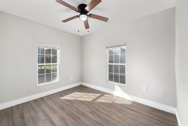 spare room with hardwood / wood-style floors and ceiling fan