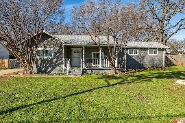 ranch-style home featuring a front yard and covered porch