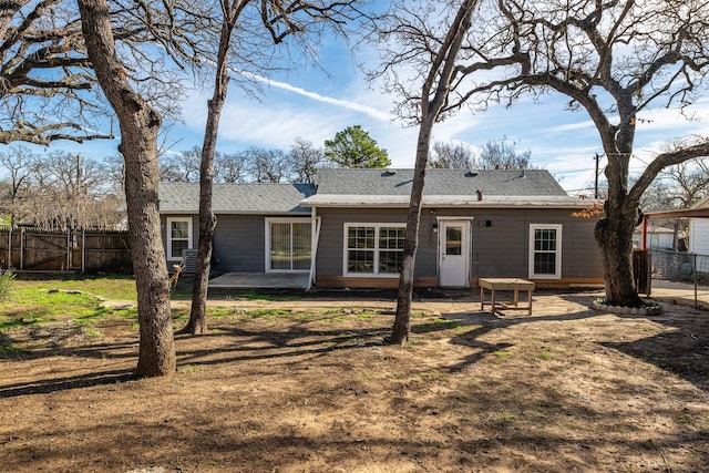 rear view of property featuring a lawn and a patio area