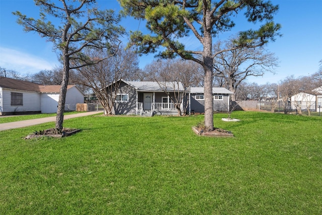 ranch-style house with covered porch and a front lawn