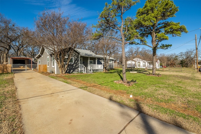 ranch-style home featuring covered porch, a garage, and a front yard