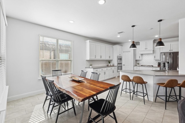 dining room with sink and light tile patterned floors