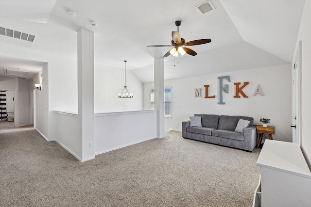 living room featuring lofted ceiling, ceiling fan with notable chandelier, and carpet