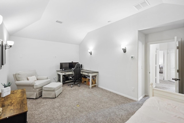 carpeted home office featuring vaulted ceiling