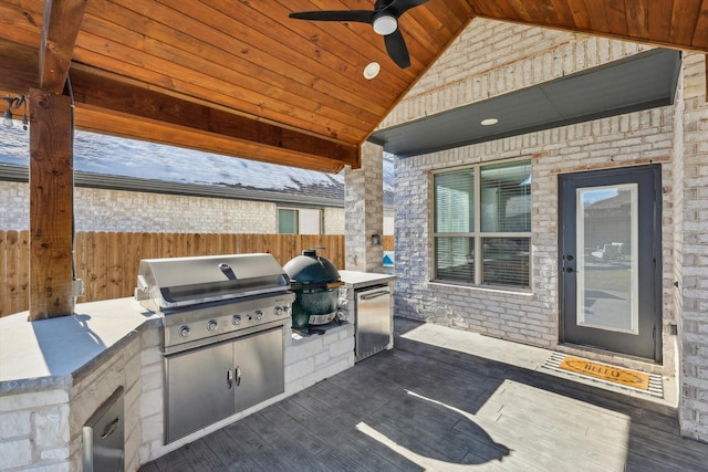 view of patio with grilling area, area for grilling, and ceiling fan